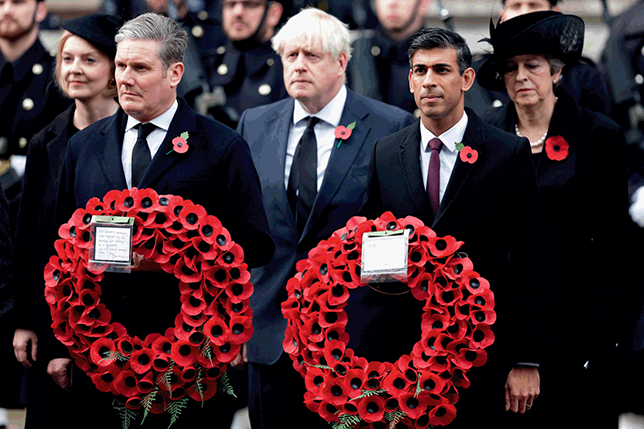 Five recent Prime Ministers of the United Kingdom, standing in silence at a memorial event for Remembrance Day. See long description.
