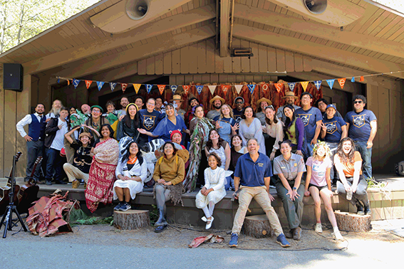 Forty-one people, aged between eight and sixty, pose together on stage for a cast and crew photo of A Midsummer Night’s Dream.