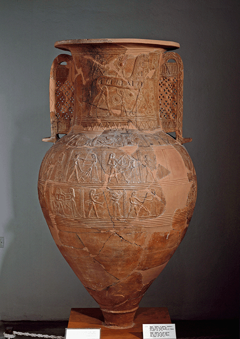 A fragmented terracotta pithos (large storage jar) from Mykonos, is decorated with horizontal bands of relief carvings depicting figural scenes and geometric patterns characteristic of Archaic Greek art.