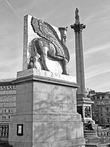 A public square with two monuments. Foreground features a lateral view of a large Assyrian lamassu statue on a stone plinth. To its right, Nelson’s Column rises in the midground. Classical buildings and a bright sky are in the background.