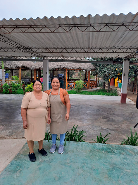 Giovanna Inoñán and her mother inside their restaurant El Potrero, posing together.
