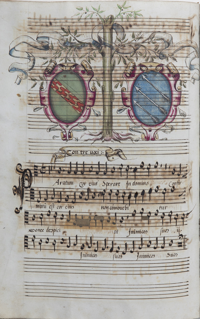 A full page from a 16th-century music manuscript. The bottom half has music; the top has a drawing of an olive tree. On either side of the central trunk are two oval coats of arms in ornate gold and red frames. See long description.