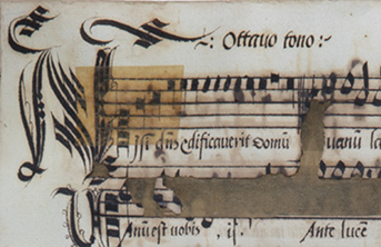 A small section of a 16th-century music manuscript. The first bar of music is written in black chant notation. The music continues in white notation, which is barely visible on the second system because of damage. See long description.