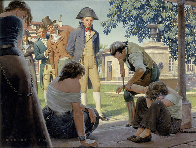 Four men watch Pinel cut chains off a woman’s wrist. The woman sits with her head down. The men and Pinel are dressed in Georgian clothing. Two other women are also chained and dressed simply. One woman is sitting, and the other is standing.