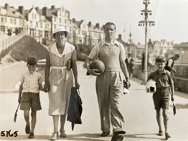 Family of four, including the father and grandfather of the author, walking along the seafront in 1934.