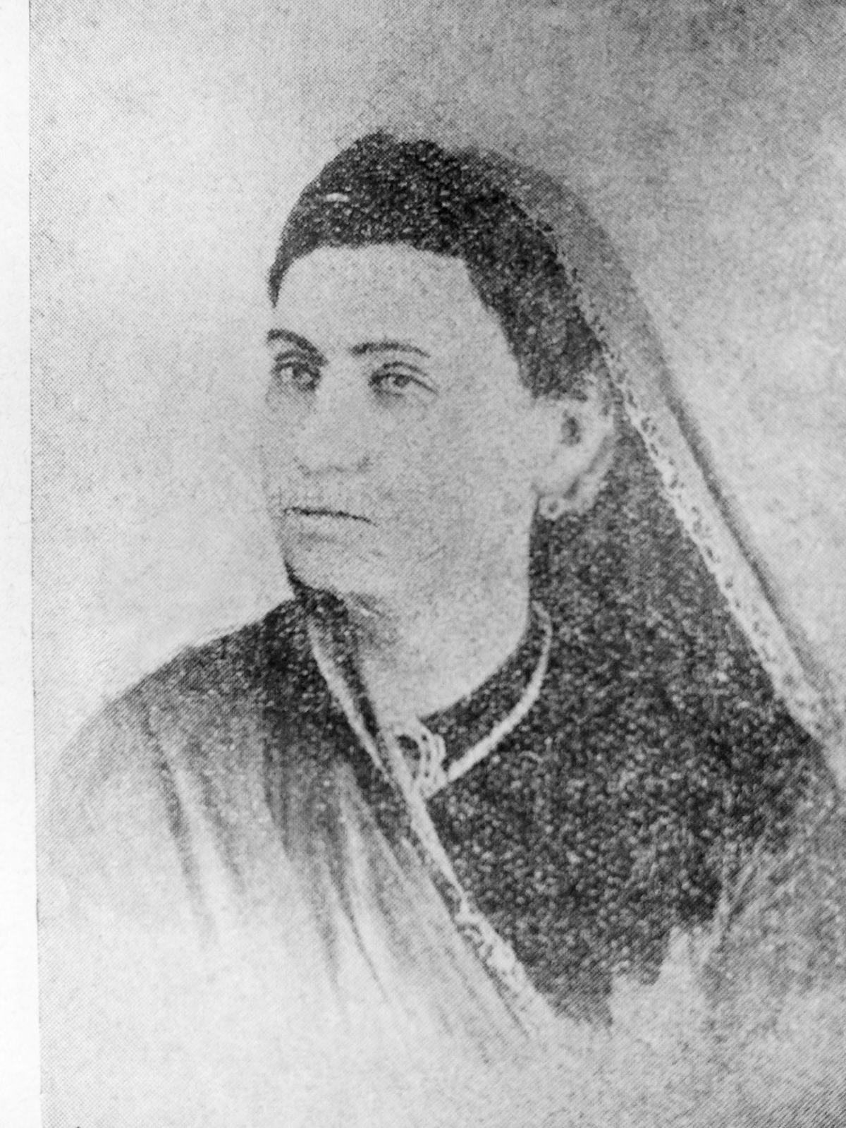 A woman in traditional attire with a blurred face. See long description.
