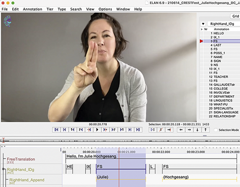 Screenshot of the ELAN file showing video with Julie in the top left. Some tiers are visible on the left. One part is highlighted in blue - F S on the RightHand_I D g tier and (Julie) on the RightHand_Append.
