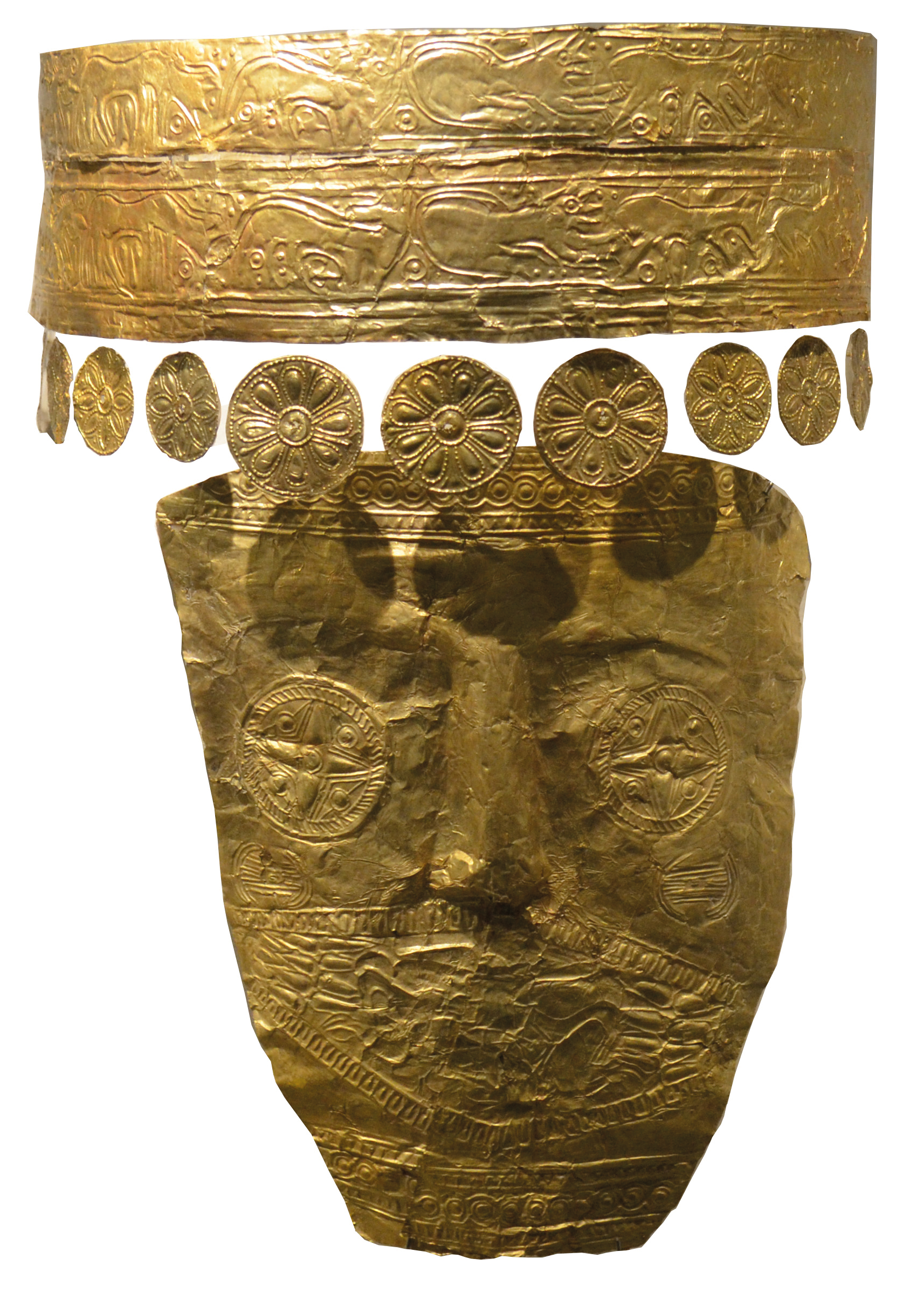 A detailed view of a gold funerary mask and headdress from an ancient burial site.