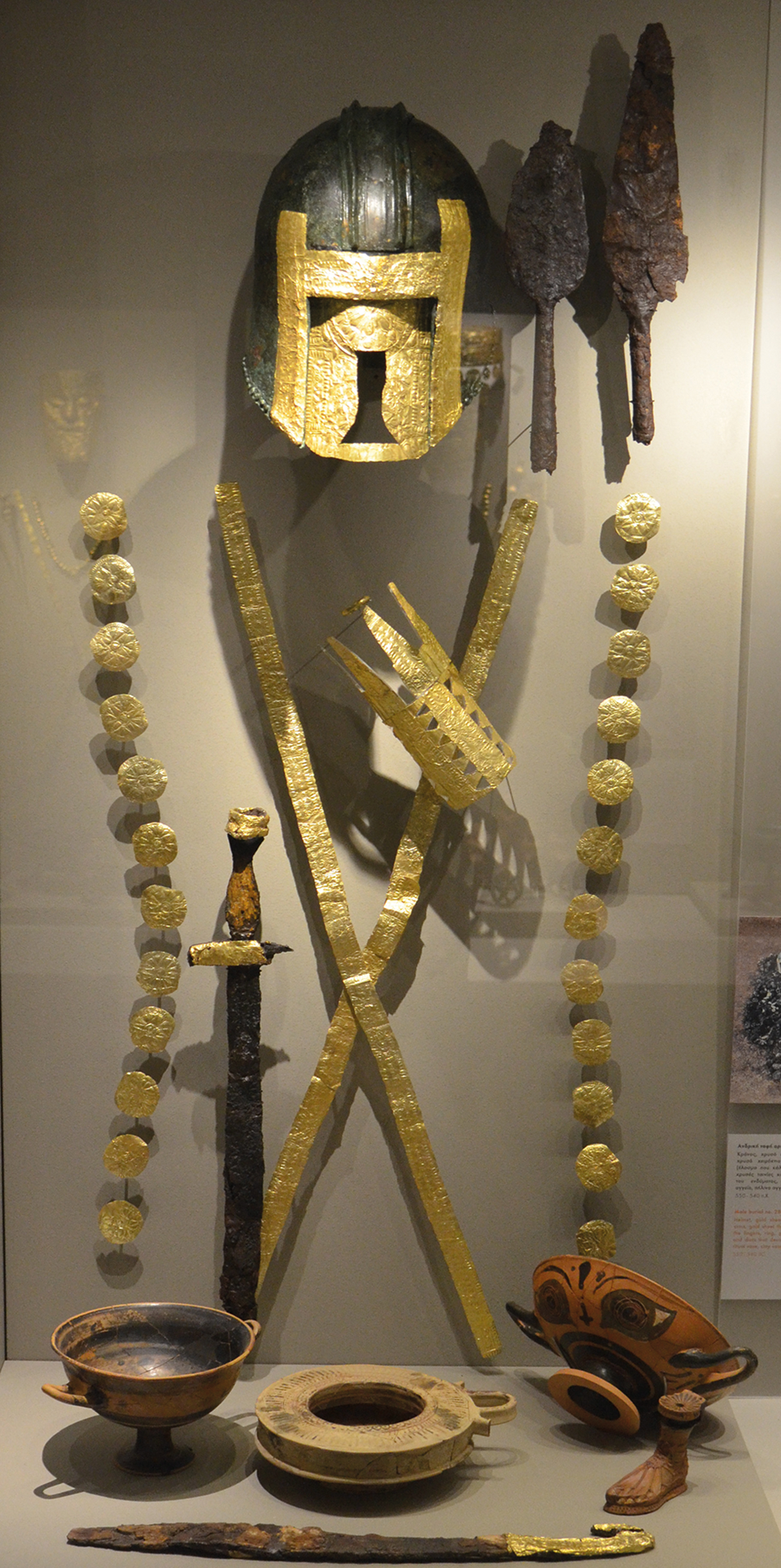 A gold full-face mask and ‘warrior’ burial artefacts displayed at Archontiko.