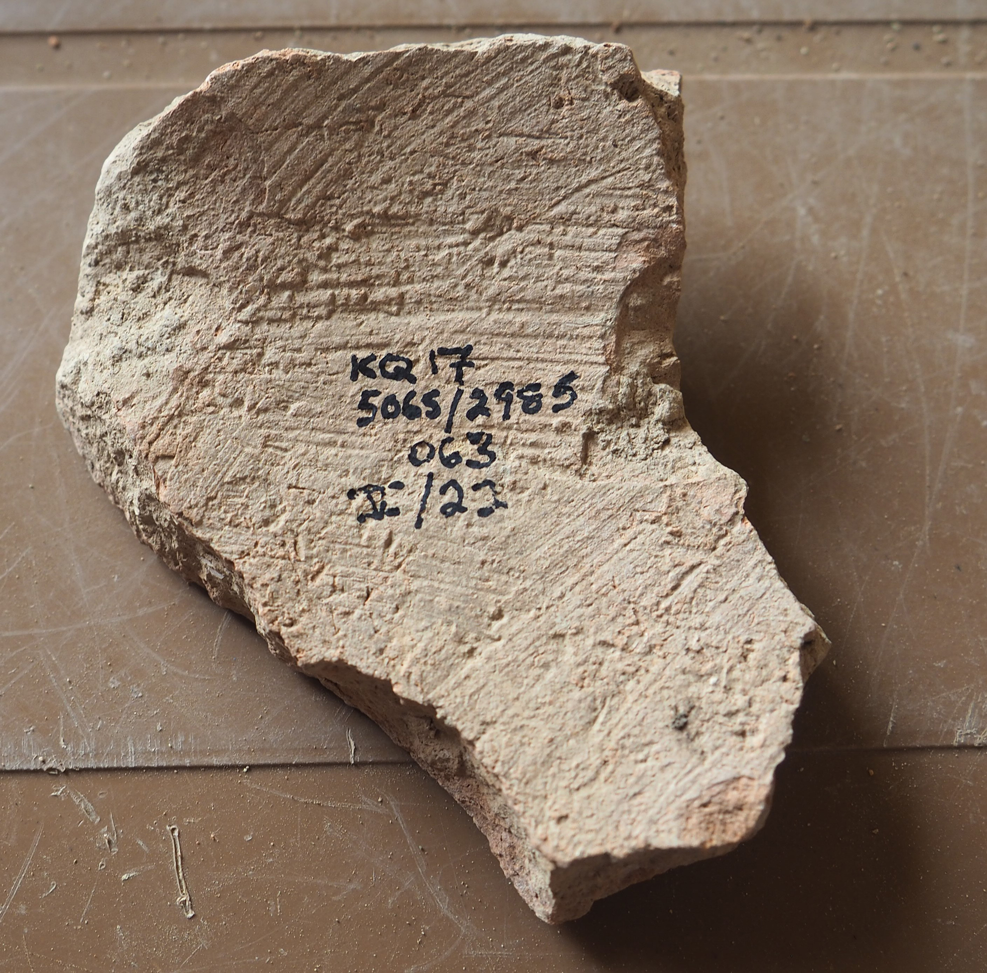 A piece of pottery with handwritten annotations.