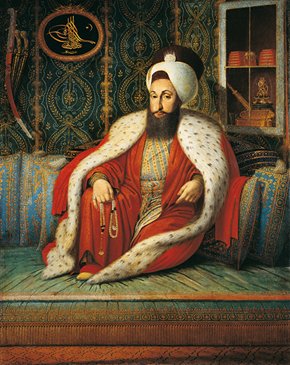 Portrait of Sultan Selim III by Konstantin Kapıdağlı, seated on a divan in an ermine-trimmed robe and a turban, holding prayer beads. Behind him, books, an inkstand, a sword, and his golden tughra symbolize intellect and authority.