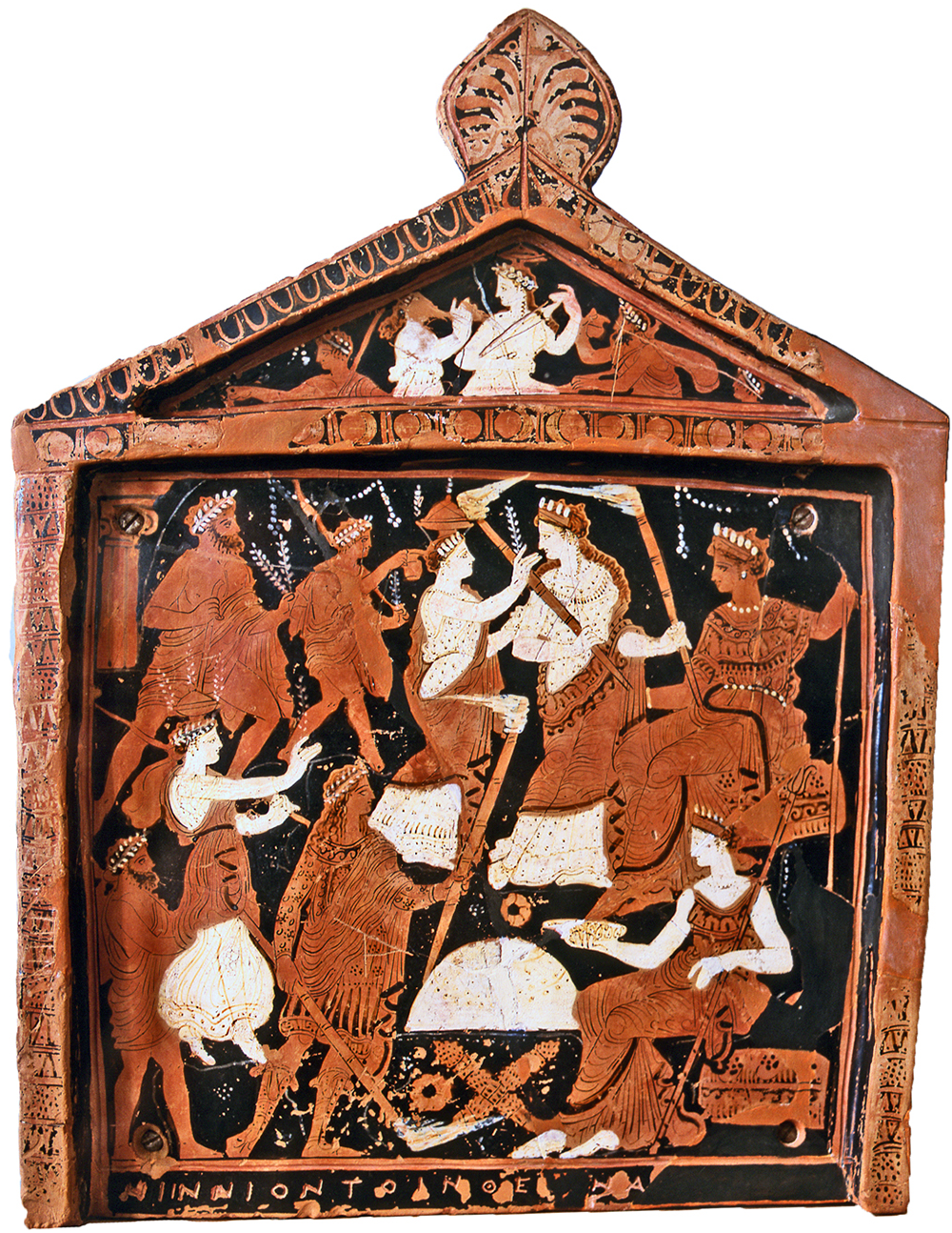 A photograph of a painted terracotta pinax showing a framed scene with several human figures and an inscription reading NINNION EPAE at the bottom. See long description.