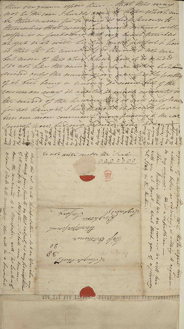 A manuscript letter with dense text and crosswriting in dark ink. The page includes the address panel and bright wax seals.