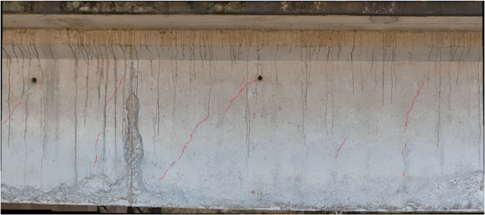 Photo of a weathered concrete bridge girder with vertical water stains and several diagonal cracks highlighted by red manual annotation lines across the span.