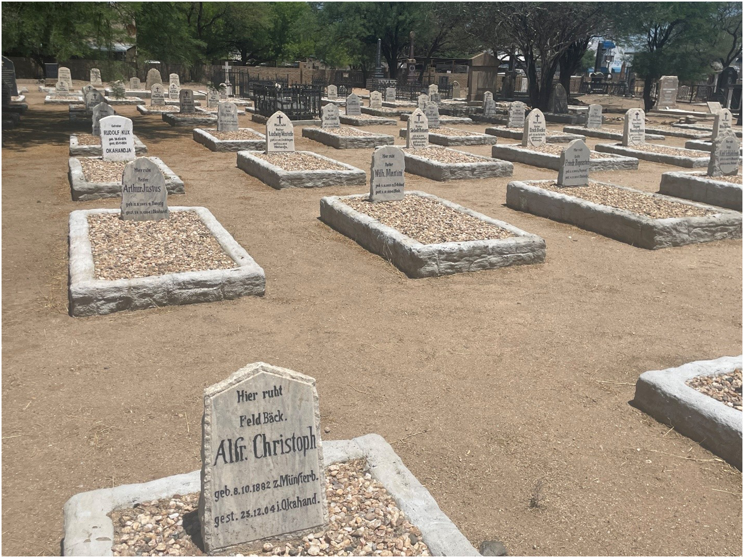 German soldier graves in a military cemetery in Okahandja, Namibia, with headstones marked with names and dates.